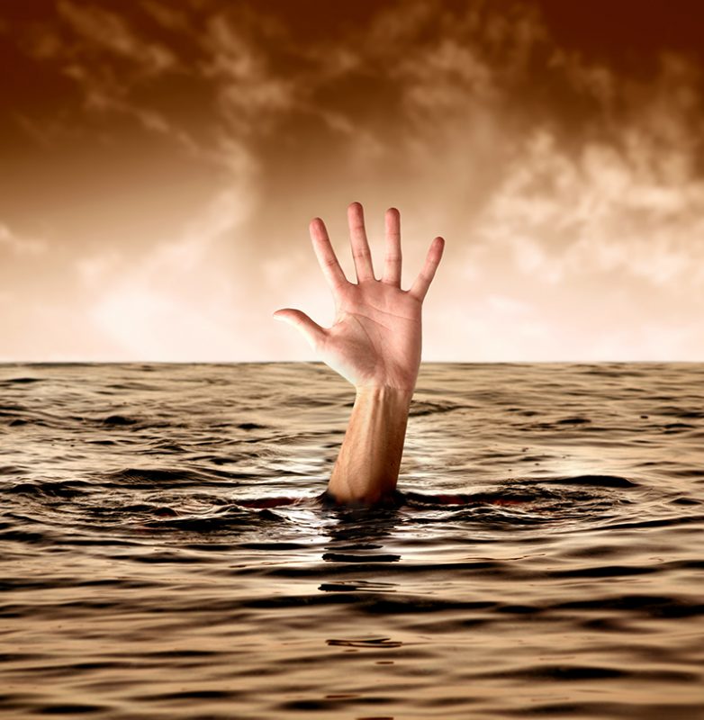 hand of man drowning in the sea