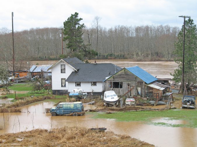 flooded farmhouse and outbuildings