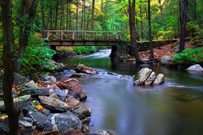 photo of a wooden bridge over a flowing river